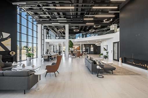 A modern open-plan office space with a mix of seating areas and natural light.