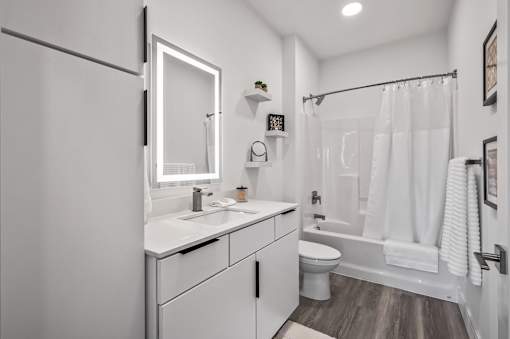 A white bathroom with a white toilet and a white sink.