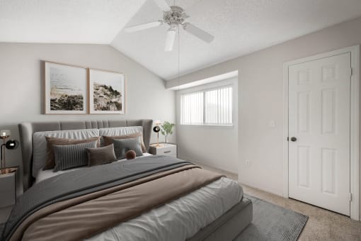 a bedroom with a large bed and a ceiling fan