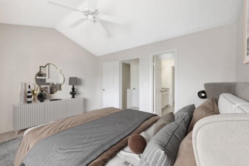 a bedroom with a large bed and a ceiling fan