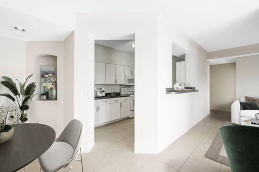a living room and kitchen with a table and chairs