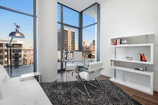 A modern living room with a large window overlooking the city.