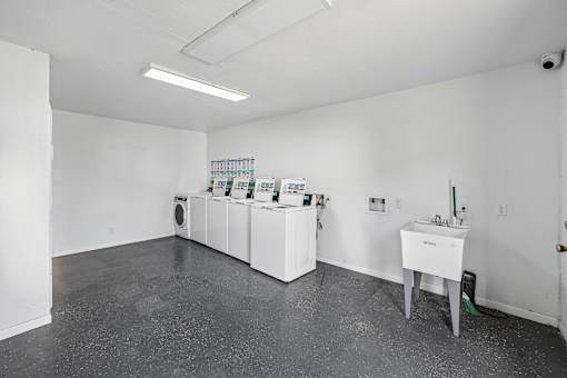 A white room with a table and a wall-mounted cabinet.