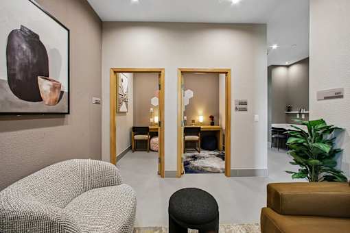A living room with a grey chair and a brown couch.