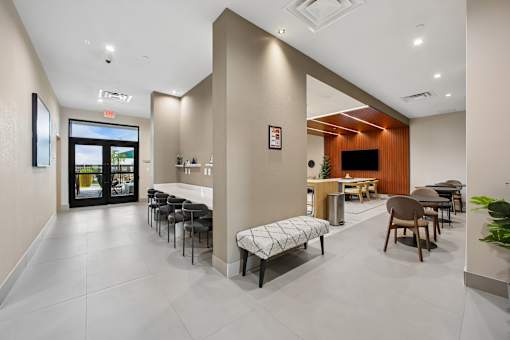A modern dining area with a long table and chairs.