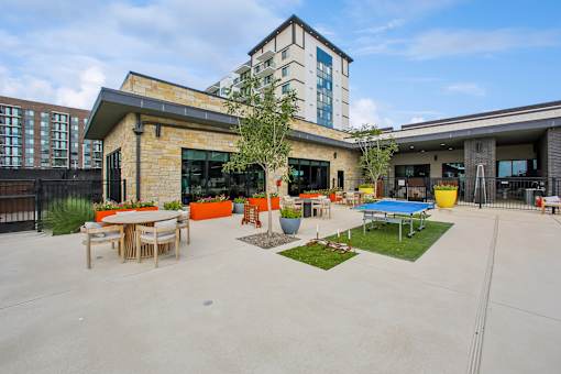 A large building with a patio area in front.