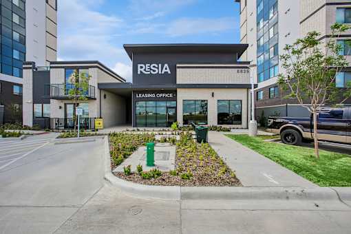 A modern building with the sign "RESIDA" on the front.
