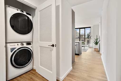 A white washing machine and dryer in a small laundry room.
