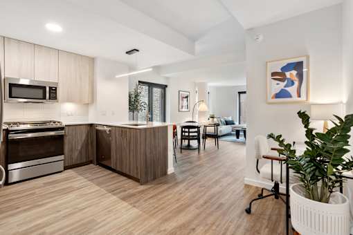 A modern kitchen with wooden floors and a large island.