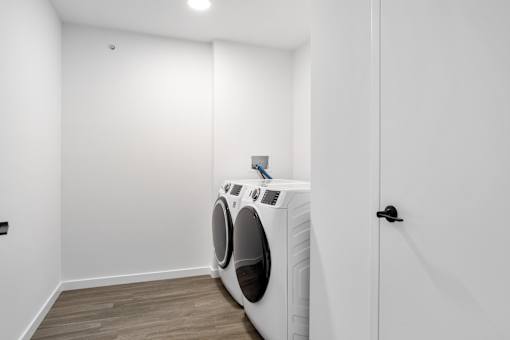 A white washing machine is in a small room.