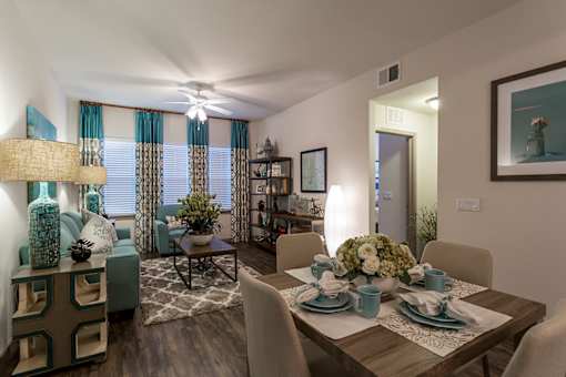 A dining room with a table set for a meal.