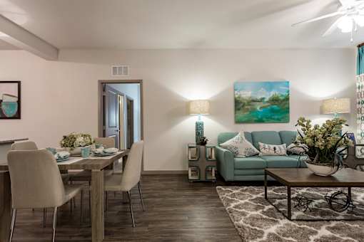 A living room with a dining table and chairs.