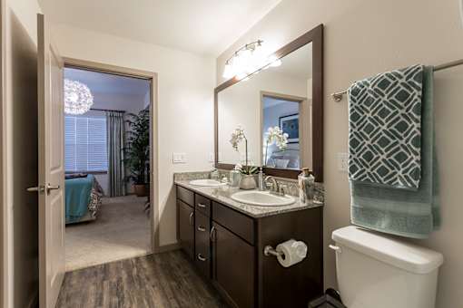 A bathroom with a sink, mirror, and toilet.