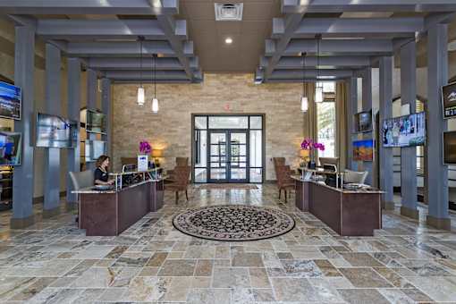 A reception area with a woman sitting behind the desk.