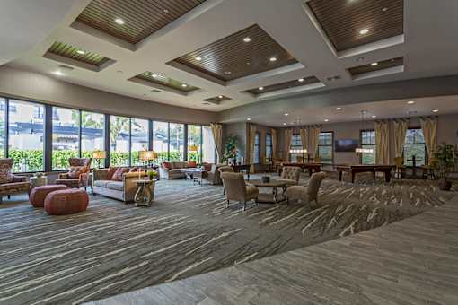 A spacious living room with wooden floors and furniture.
