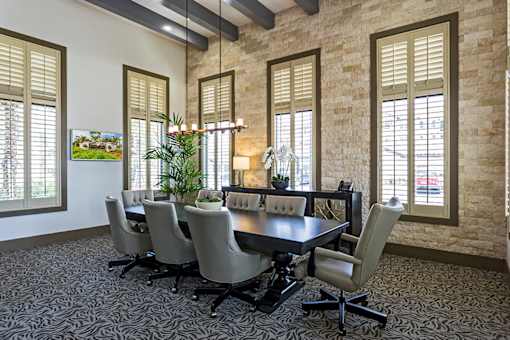 A conference room with a long table and chairs.