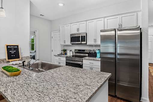 A kitchen with granite countertops and stainless steel appliances.