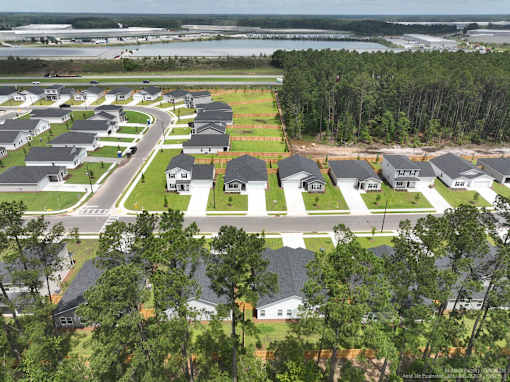 A bird's eye view of a residential area with houses and trees.