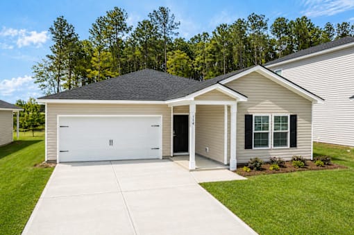 A two-car garage with a white door is attached to a house.