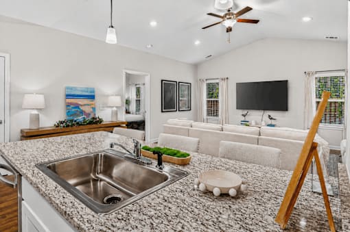 A kitchen with a granite countertop and a sink.