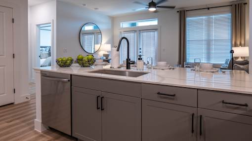 A modern bathroom with a large mirror and a sink.