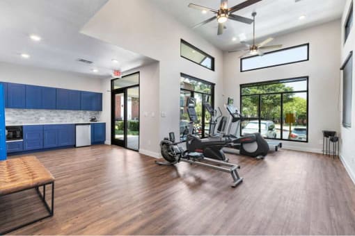 a gym with a reformer exercise bike and a window