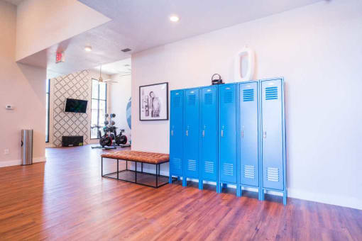 a large room with blue lockers in the middle of it