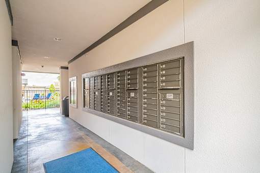 A long hallway with a mailbox on the wall.