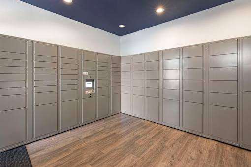 A room with wooden floors and grey lockers.