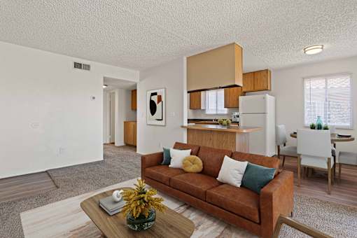 A living room with a brown couch and a coffee table.