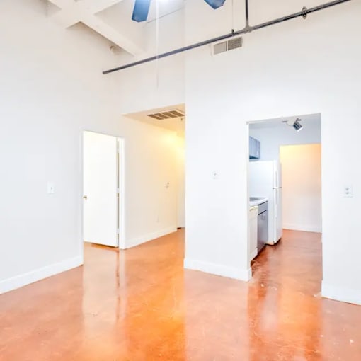 A room with a white door and a white refrigerator.