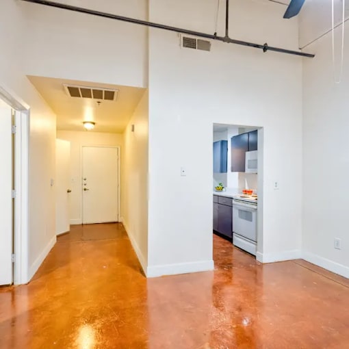 A long hallway with a kitchen at the end.
