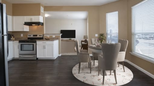 a kitchen and dining room with a table and chairs