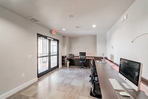 A modern home office with a desk, computer, and chair.