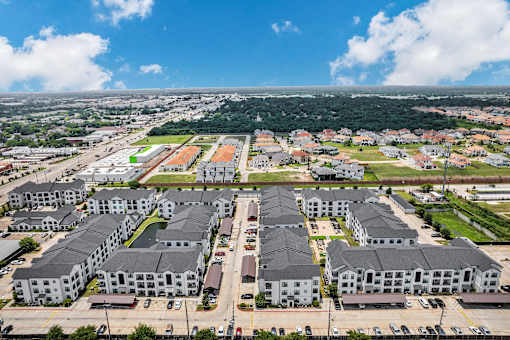 A large apartment complex with multiple buildings and parking lots.