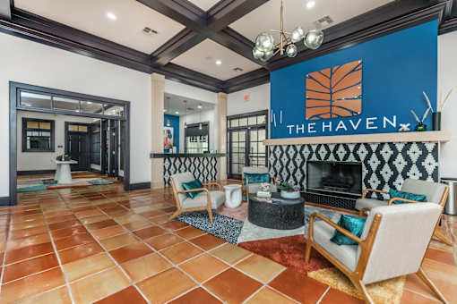 A living room with a fireplace and a sign that says "The Haven.".