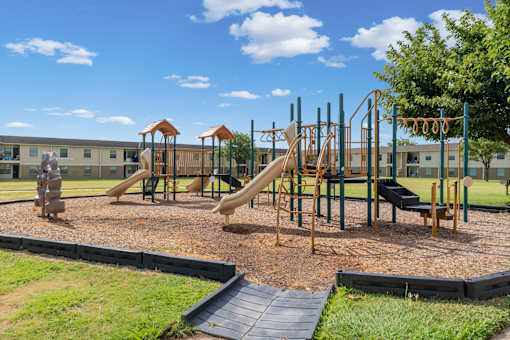 A playground with a slide, swings, and a climbing frame.