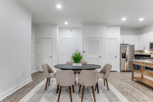 a living room with white walls and a table with chairs