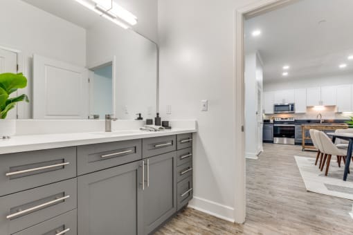 an open kitchen and dining area with a large mirror and a living room