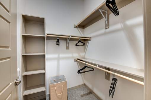 A white closet with a brown bag on the floor.