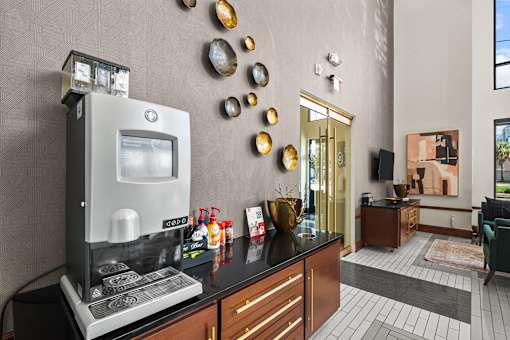 A modern kitchen with a coffee machine and a vase on the counter.