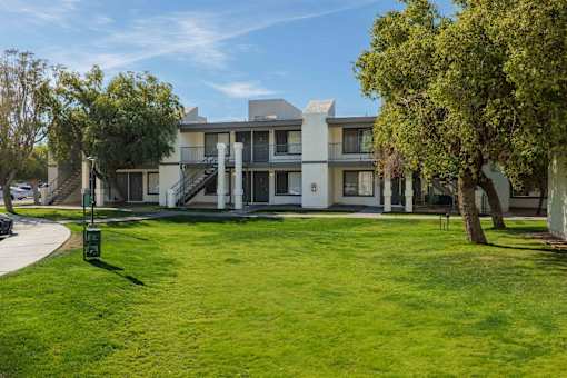 A modern building with a green lawn in front.