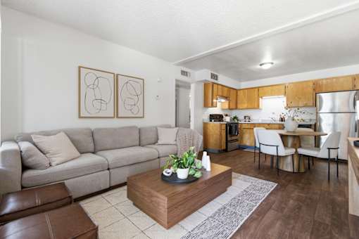 A living room with a grey couch and a coffee table in the middle.