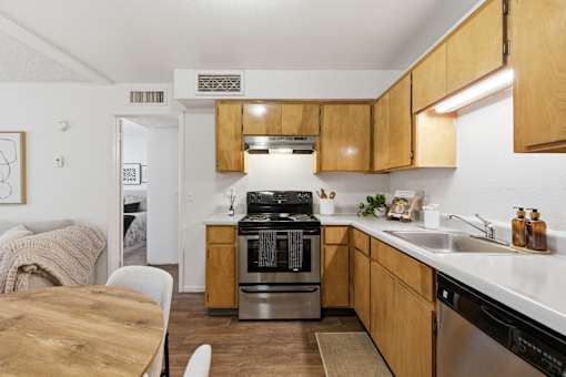 A modern kitchen with wooden cabinets and stainless steel appliances.