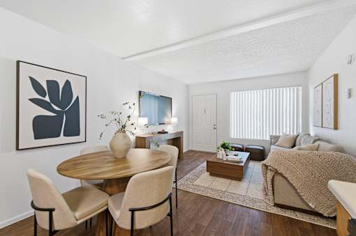 A living room with a dining table and chairs.