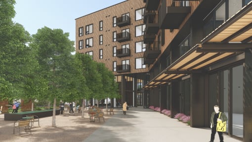 a rendering of a large building with trees and a sidewalk