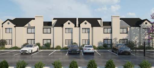 A rendering of a building with a parking lot in front.