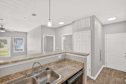 A kitchen with a sink and a window.