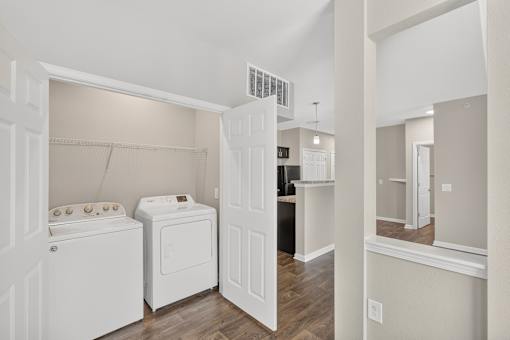 A white washer and dryer in a laundry room.