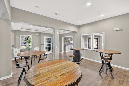 A room with a wooden table and chairs.